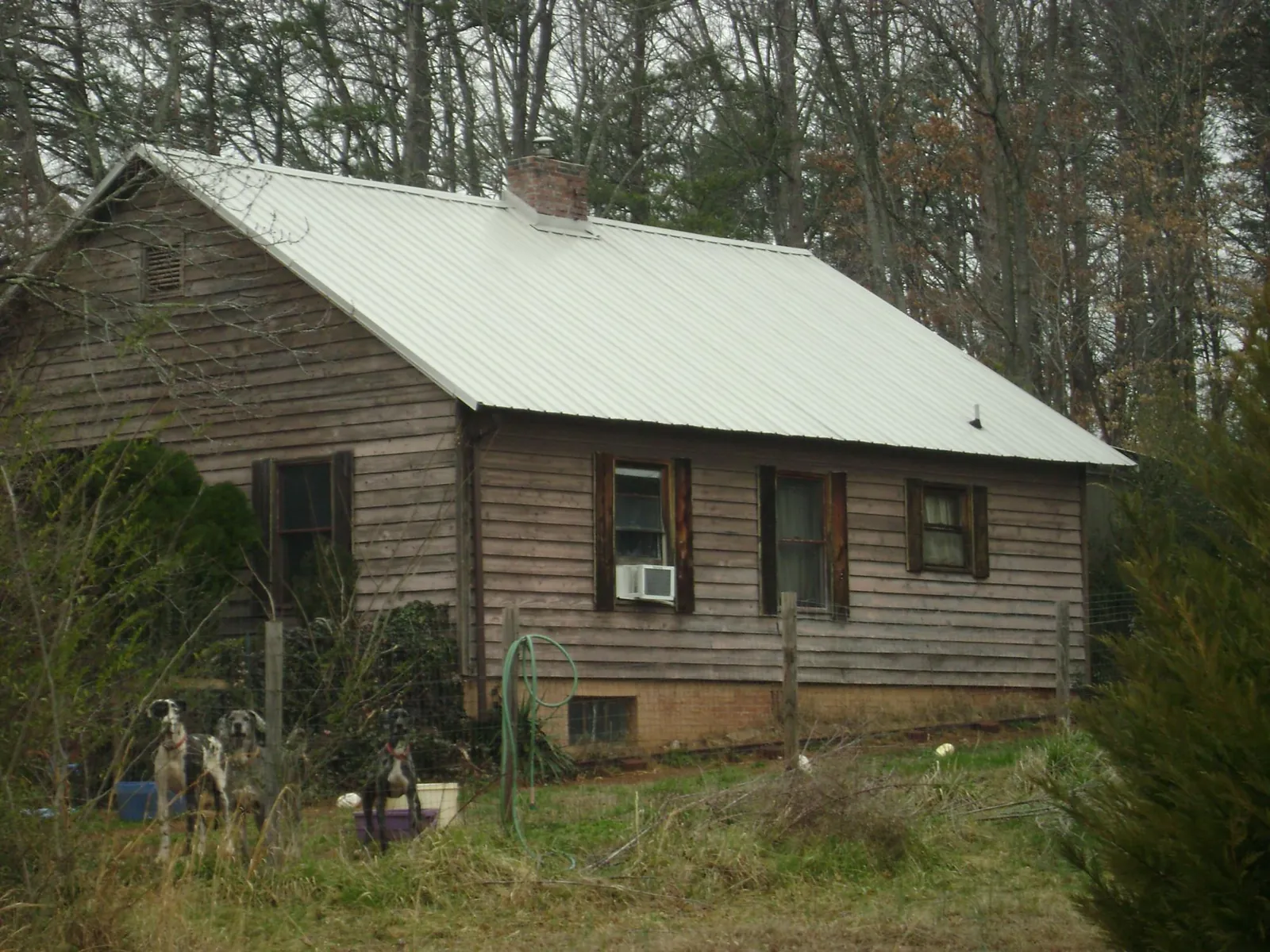 White metal roof on an old wood sided farmhouse, from a Metal Roof Installation job in Hornbeak